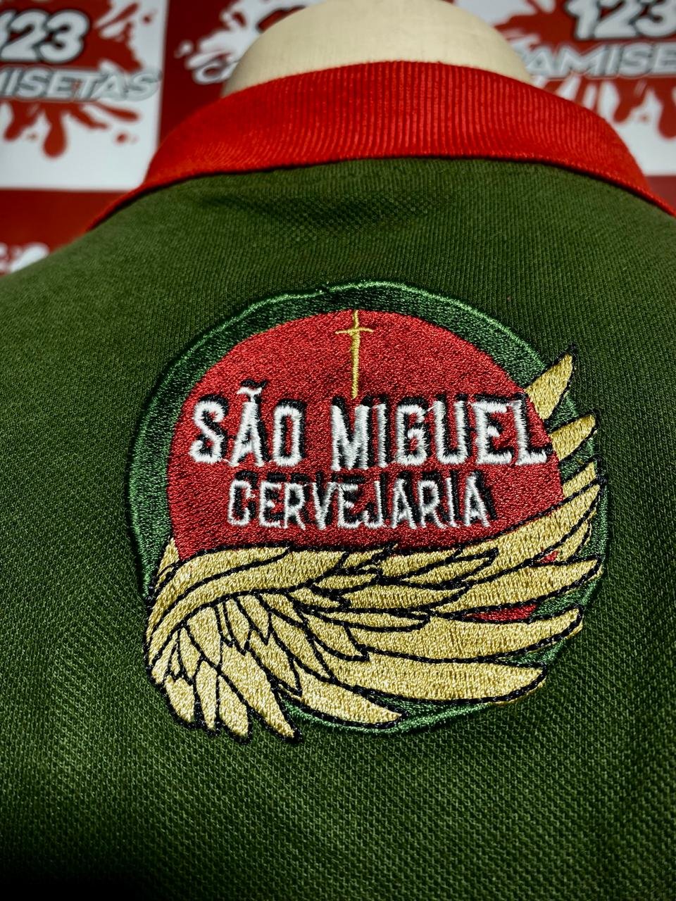 Brasão bordado nas costas de uma camisa polo